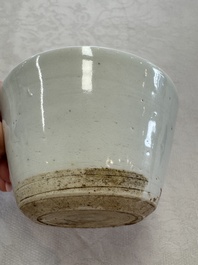 A Chinese white-glazed cup on a wooden stand, 17th C.