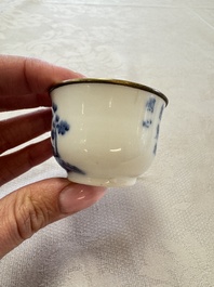 A Chinese white-glazed cup on a wooden stand, 17th C.