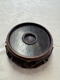 A Chinese white-glazed cup on a wooden stand, 17th C.