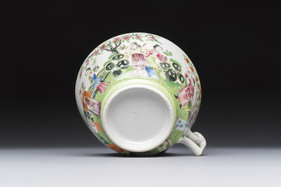 A Chinese Canton famille rose cup and saucer with figures in a garden, 19th C.