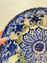 A Persian blue, white, and green glazed dish with stylised floral design, Safavid, 17/18th C.