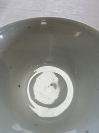 A Chinese white-glazed cup on a wooden stand, 17th C.