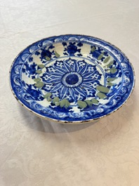 A Persian blue, white, and green glazed dish with stylised floral design, Safavid, 17/18th C.