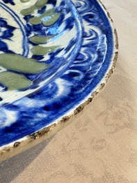 A Persian blue, white, and green glazed dish with stylised floral design, Safavid, 17/18th C.