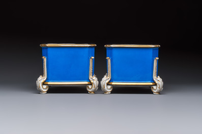 A pair of French gilt blue-ground 'Cherub' jardini&egrave;res with biscuit-relief plaques, 19/20th C.