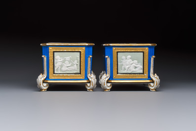 A pair of French gilt blue-ground 'Cherub' jardini&egrave;res with biscuit-relief plaques, 19/20th C.