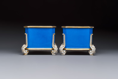 A pair of French gilt blue-ground 'Cherub' jardini&egrave;res with biscuit-relief plaques, 19/20th C.