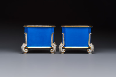 A pair of French gilt blue-ground 'Cherub' jardini&egrave;res with biscuit-relief plaques, 19/20th C.