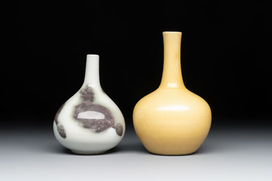 A Chinese copper-red and white 'Mythical Beasts' vase and a yellow-glazed bottle vase, on later wooden stands, Kangxi and later