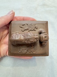 A Chinese Yixing stoneware 'lion and brocade ball' teapot and cover, 19/20th C.