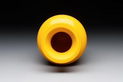 A Chinese yellow Peking glass vase on a wooden stand, 19th C.