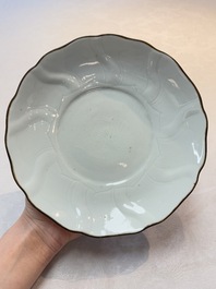 A Chinese moulded white-glazed plate with anhua floral design and a copper-mounted rim, Xuande mark, late Ming