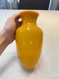 A Chinese yellow Peking glass vase on a wooden stand, 19th C.
