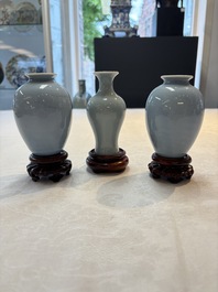 Three Chinese claire-de-lune vases on wooden stands, Kangxi mark, 19th C.