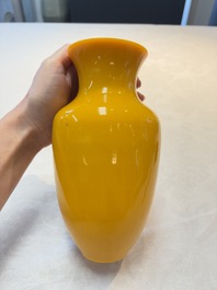 A Chinese yellow Peking glass vase on a wooden stand, 19th C.