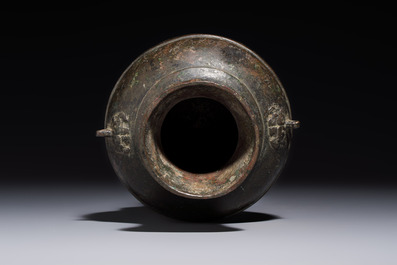 A miniature Chinese archaic bronze wine vessel with Taotie handles, 'Hu 壺', Han