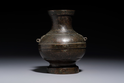 A miniature Chinese archaic bronze wine vessel with Taotie handles, 'Hu 壺', Han