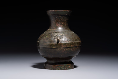 A miniature Chinese archaic bronze wine vessel with Taotie handles, 'Hu 壺', Han