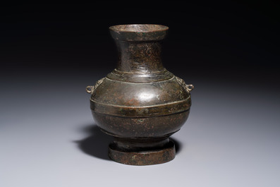 A miniature Chinese archaic bronze wine vessel with Taotie handles, 'Hu 壺', Han
