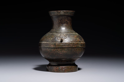 A miniature Chinese archaic bronze wine vessel with Taotie handles, 'Hu 壺', Han