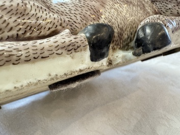 A pair of Chinese aubergine-glazed models of recumbent deer, 18/19th C.