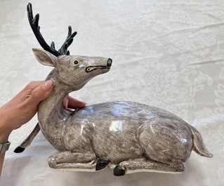 A pair of Chinese aubergine-glazed models of recumbent deer, 18/19th C.