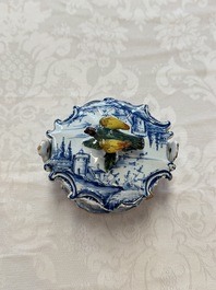 A blue and white Dutch Delft butter tub with a polychrome bird-shaped finial, 18th C.