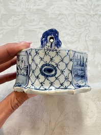 A blue and white Dutch Delft butter tub with a polychrome bird-shaped finial, 18th C.