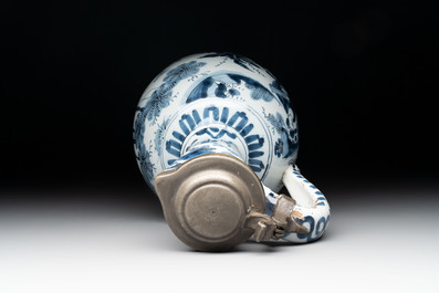 A blue and white Dutch Delft ewer with a mounted pewter lid, 17th C.
