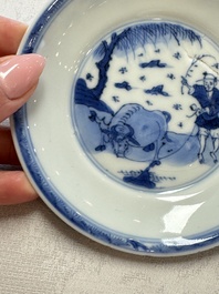 23 Chinese blue and white saucers with figural design, Yongzheng/Kangxi