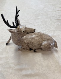 A pair of Chinese aubergine-glazed models of recumbent deer, 18/19th C.