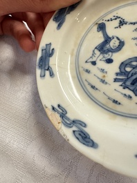 23 Chinese blue and white saucers with figural design, Yongzheng/Kangxi