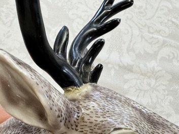 A pair of Chinese aubergine-glazed models of recumbent deer, 18/19th C.