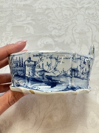 A blue and white Dutch Delft butter tub with a polychrome bird-shaped finial, 18th C.