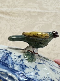 A blue and white Dutch Delft butter tub with a polychrome bird-shaped finial, 18th C.