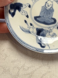 23 Chinese blue and white saucers with figural design, Yongzheng/Kangxi