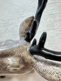 A pair of Chinese aubergine-glazed models of recumbent deer, 18/19th C.