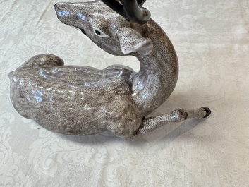 A pair of Chinese aubergine-glazed models of recumbent deer, 18/19th C.