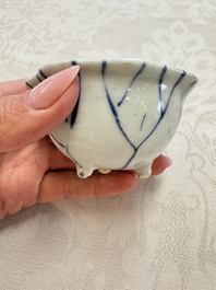 A Chinese Nanking water pot, a blue and white brush pot, a jarlet and a trick cup, Ming and later