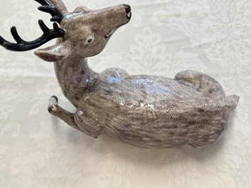A pair of Chinese aubergine-glazed models of recumbent deer, 18/19th C.