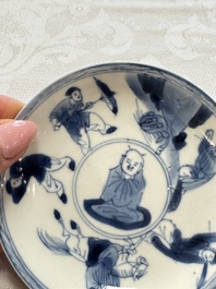 23 Chinese blue and white saucers with figural design, Yongzheng/Kangxi