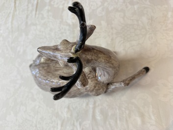 A pair of Chinese aubergine-glazed models of recumbent deer, 18/19th C.