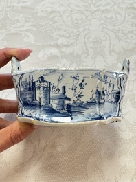 A blue and white Dutch Delft butter tub with a polychrome bird-shaped finial, 18th C.