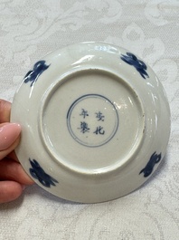 23 Chinese blue and white saucers with figural design, Yongzheng/Kangxi