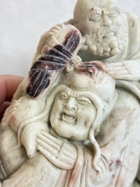 A Chinese carved soapstone 'Luohan' group on a wooden stand, Republic