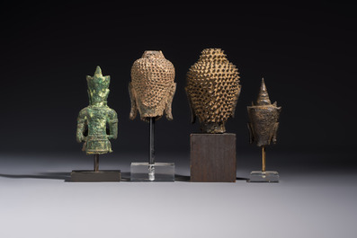 A bronze standing Buddha, a torso of Buddha and four heads of Buddha, Thailand, 17/18th C.