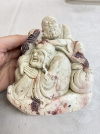 A Chinese carved soapstone 'Luohan' group on a wooden stand, Republic