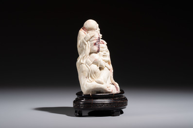 A Chinese carved soapstone 'Luohan' group on a wooden stand, Republic