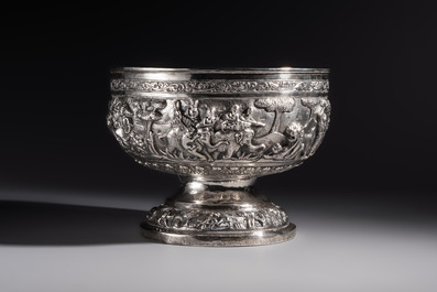 A large repouss&eacute; silver footed bowl depicting a hunting scene, India, late 19/early 20th C.