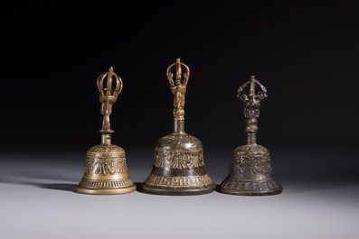 Three Tibetan bronze ritual bells and a bronze Buddha, 19th C.